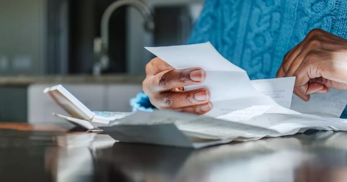 0_woman-reviews-receipts-at-kitchen-table